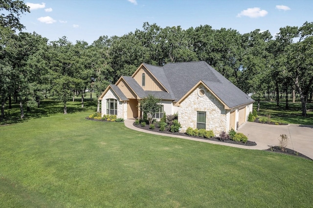 view of front of house featuring a front lawn, driveway, stone siding, board and batten siding, and a garage
