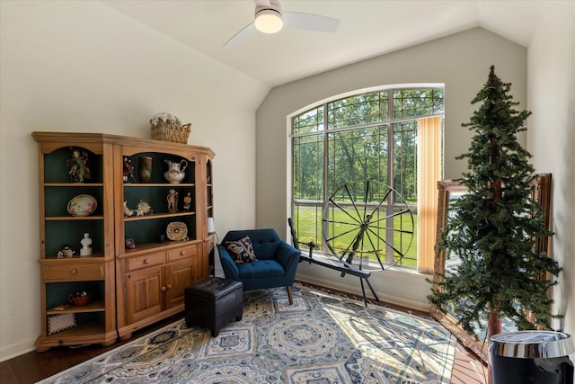 living area featuring plenty of natural light, vaulted ceiling, and wood finished floors