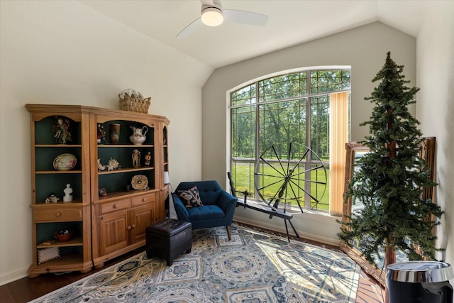 sitting room featuring lofted ceiling, a ceiling fan, wood finished floors, and baseboards