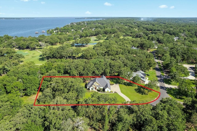 drone / aerial view featuring a water view and a wooded view