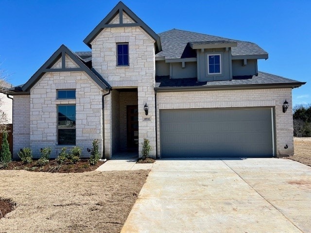 view of front facade with a garage, concrete driveway, brick siding, and a shingled roof