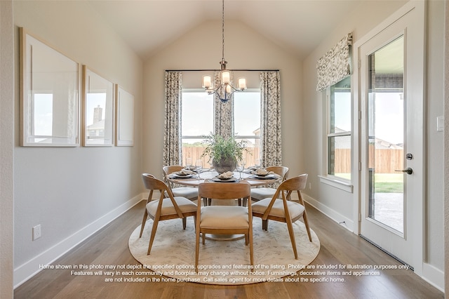 dining area with lofted ceiling, wood finished floors, and baseboards