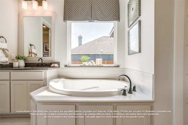 bathroom featuring a garden tub and vanity