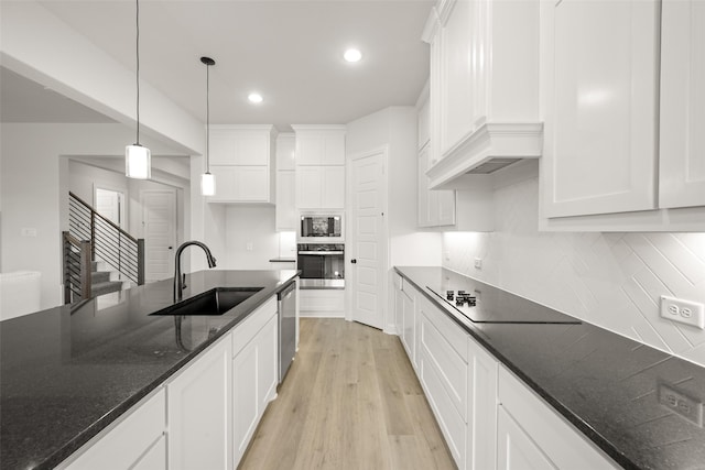 4814 Nomad Dr, Midlothian, TX 76065 - kitchen featuring a sink, appliances with stainless steel finishes, white cabinets, light wood-type flooring, and hanging light fixtures