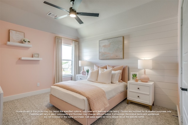 bedroom featuring carpet floors, a ceiling fan, visible vents, vaulted ceiling, and baseboards