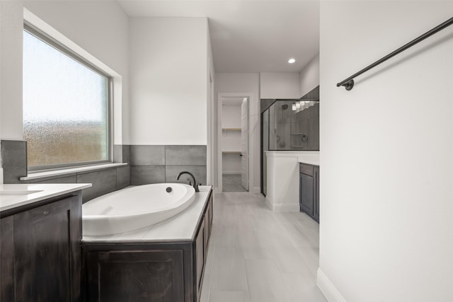 4814 Nomad Dr, Midlothian, TX 76065 - bathroom featuring a stall shower, a garden tub, and vanity