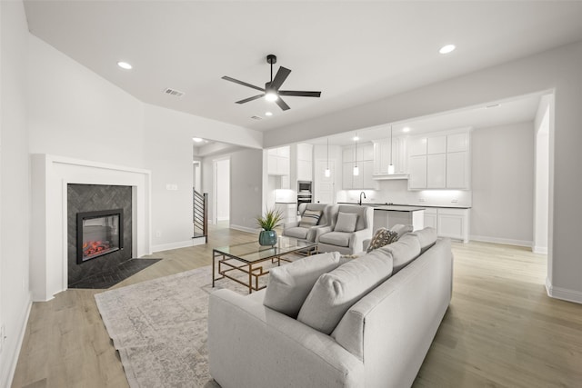 4814 Nomad Dr, Midlothian, TX 76065 - living area featuring ceiling fan, light wood-style flooring, baseboards, recessed lighting, and a fireplace