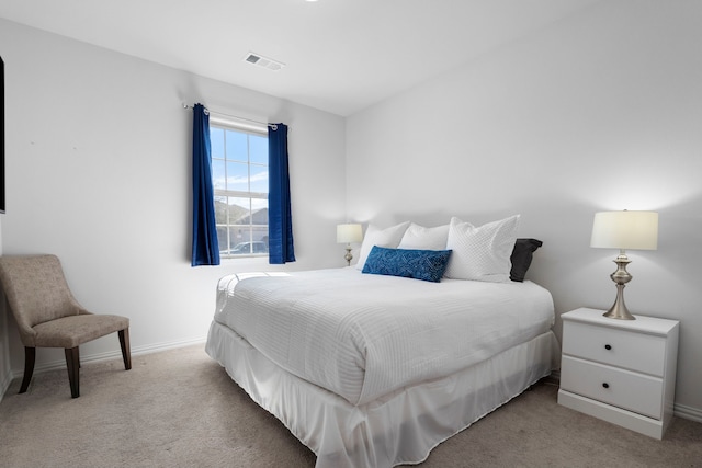 bedroom featuring baseboards, visible vents, and carpet flooring