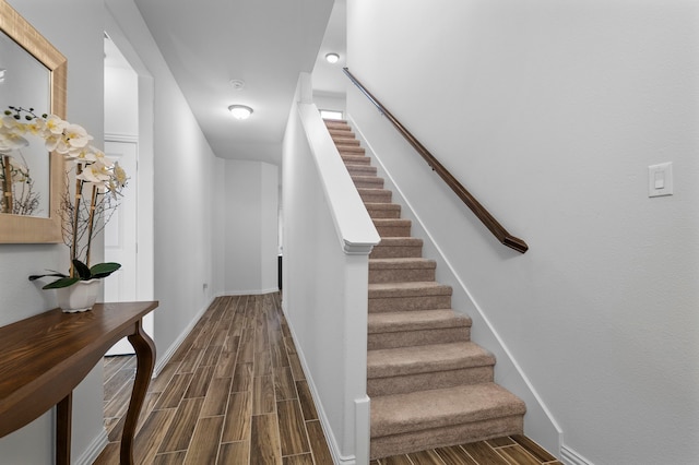 stairway with baseboards and wood tiled floor