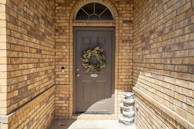 property entrance featuring brick siding