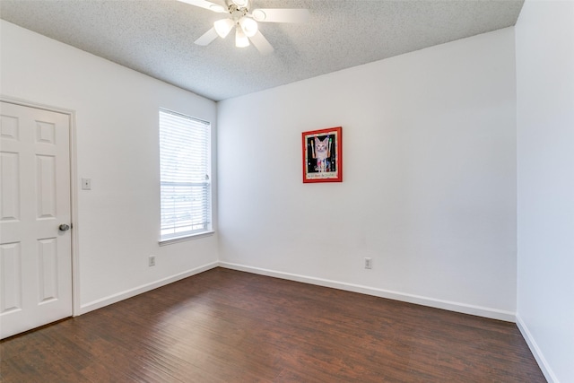 unfurnished room with dark wood-style floors, ceiling fan, baseboards, and a textured ceiling