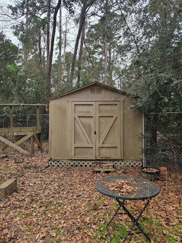 view of shed with fence