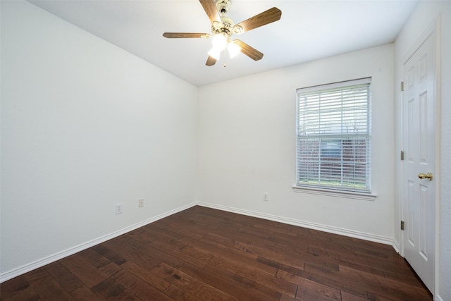 unfurnished room featuring ceiling fan, baseboards, and dark wood finished floors