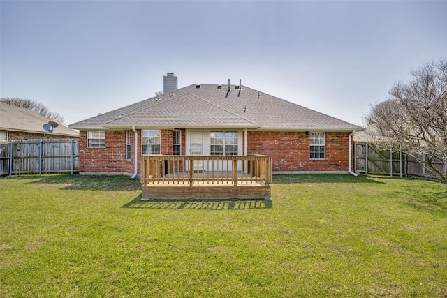 rear view of house featuring a fenced backyard, a chimney, and brick siding