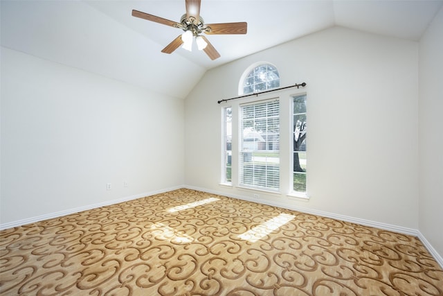 unfurnished room with lofted ceiling, ceiling fan, and baseboards