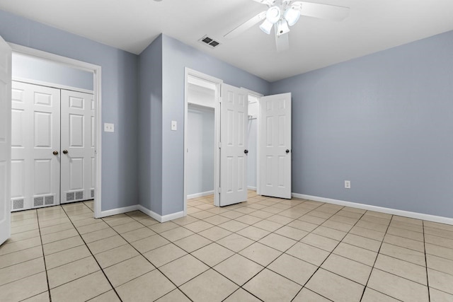 unfurnished bedroom with a closet, visible vents, and baseboards