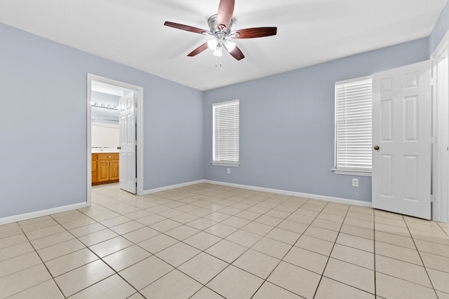 unfurnished bedroom with baseboards, a ceiling fan, and light tile patterned flooring