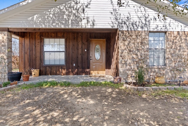 view of exterior entry featuring board and batten siding