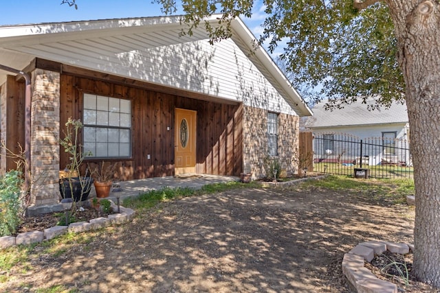 view of front of home featuring fence