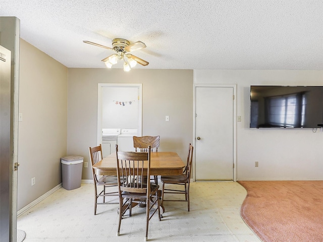 dining space featuring a textured ceiling, separate washer and dryer, a ceiling fan, and baseboards