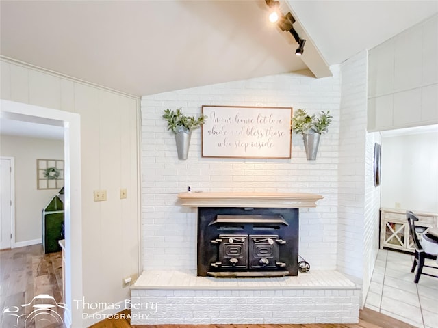 room details featuring wood finished floors, beam ceiling, and track lighting