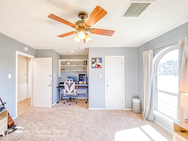 carpeted bedroom with ceiling fan, multiple windows, visible vents, and baseboards