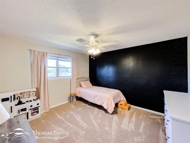 bedroom featuring light colored carpet, visible vents, ceiling fan, and baseboards