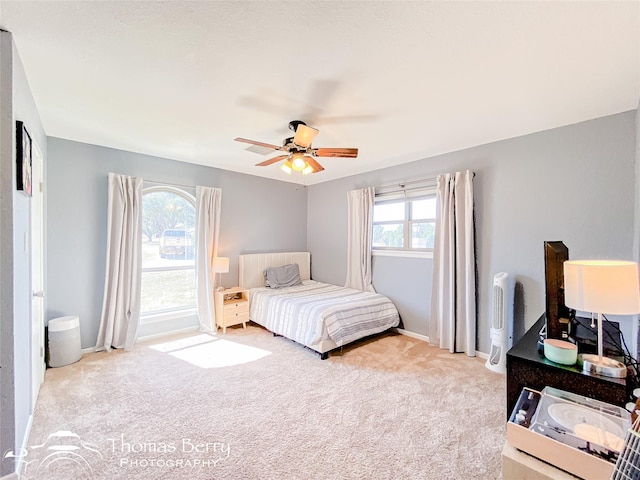 bedroom with carpet, baseboards, and ceiling fan