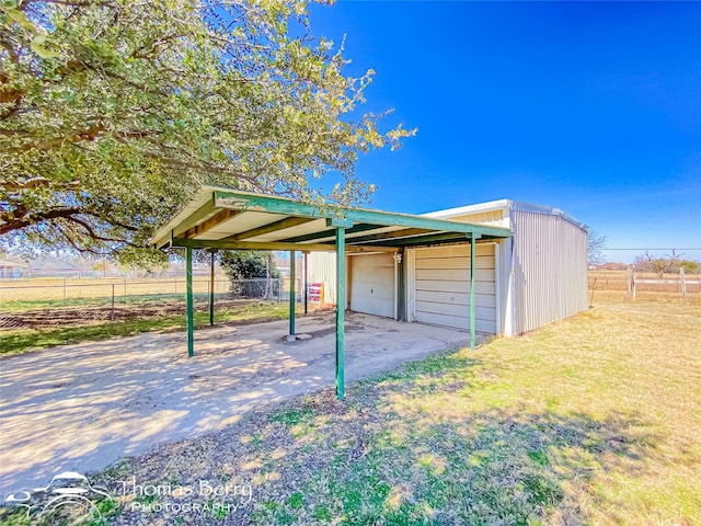 view of outbuilding featuring an outbuilding and fence