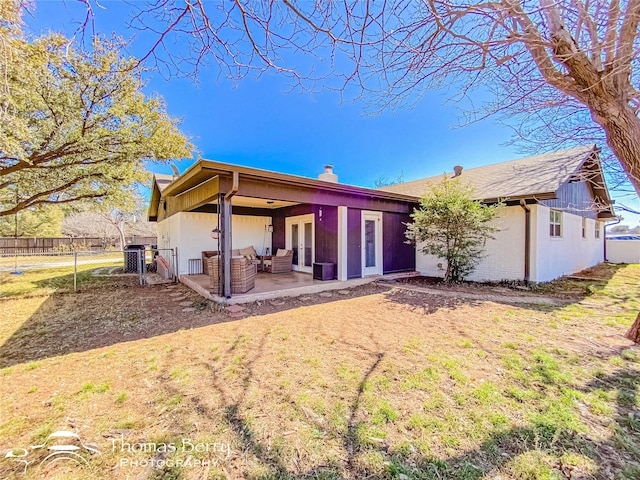 back of house featuring french doors, a chimney, a lawn, a patio area, and fence