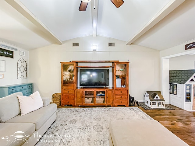 living area with a ceiling fan, visible vents, lofted ceiling with beams, and wood finished floors