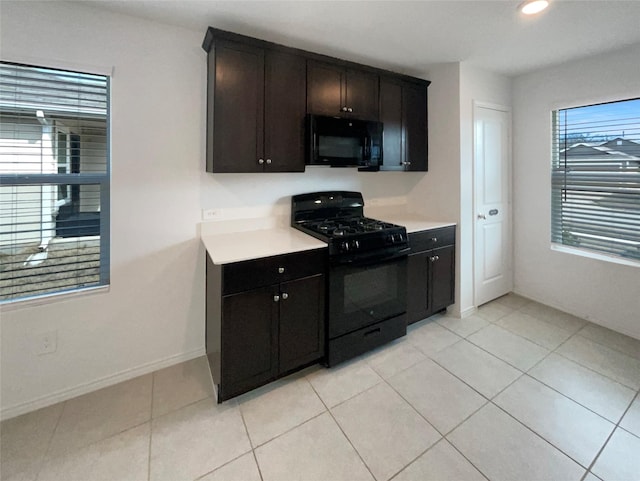 kitchen with light tile patterned floors, recessed lighting, light countertops, black appliances, and baseboards