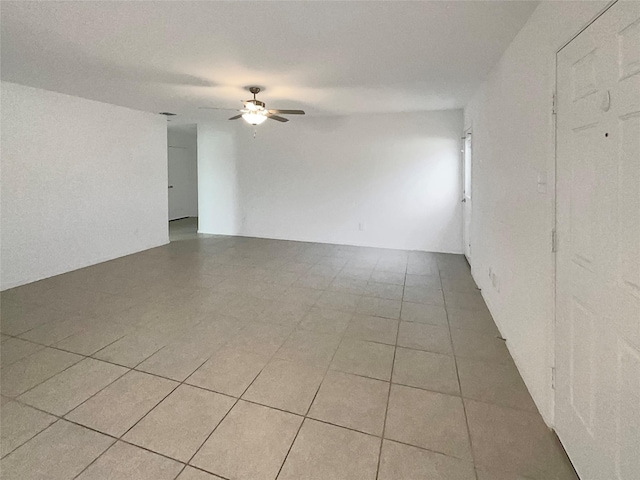 unfurnished room featuring ceiling fan and light tile patterned floors