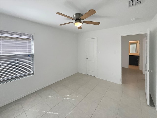 unfurnished bedroom with a ceiling fan, visible vents, and light tile patterned flooring