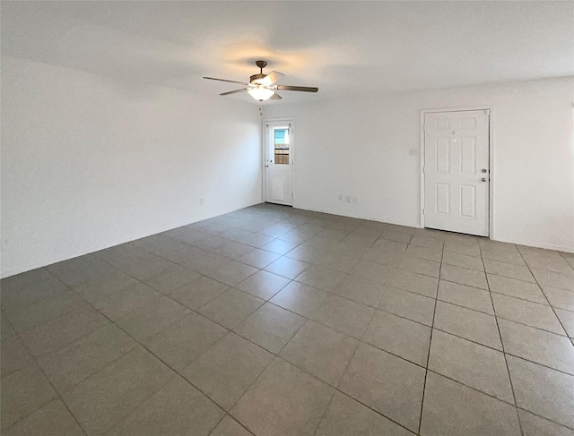 unfurnished room featuring tile patterned flooring and a ceiling fan