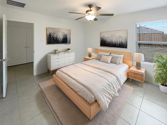 bedroom with a ceiling fan, visible vents, and light tile patterned flooring