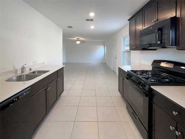 kitchen featuring black appliances, light tile patterned floors, visible vents, and a sink