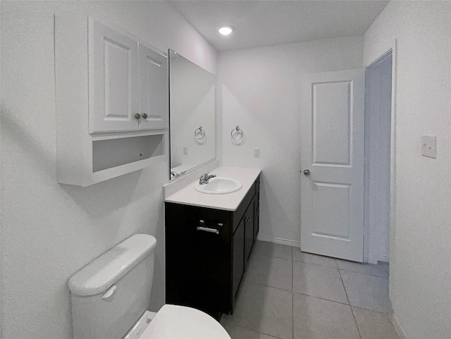 bathroom with tile patterned flooring, vanity, and toilet