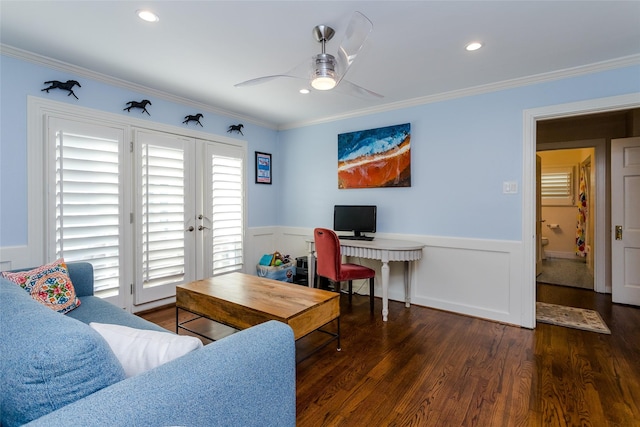 living room with a wainscoted wall, ceiling fan, wood finished floors, and crown molding