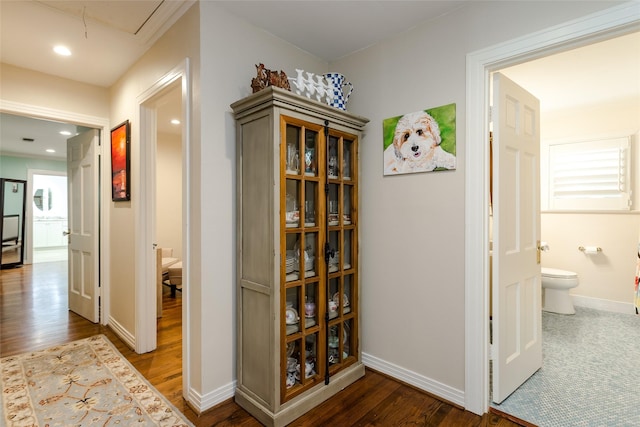 corridor featuring recessed lighting, wood finished floors, attic access, and baseboards