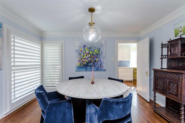 dining space with ornamental molding, dark wood-style flooring, and a healthy amount of sunlight