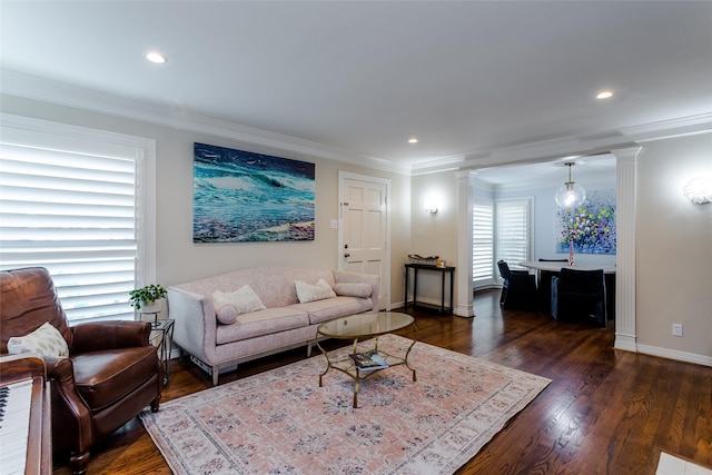 living room featuring crown molding, dark wood-type flooring, decorative columns, and baseboards