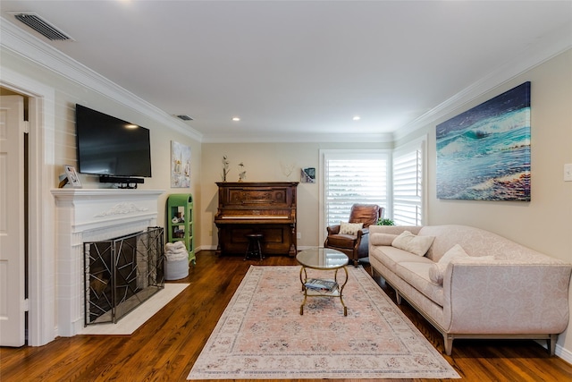 living room with dark wood finished floors, visible vents, ornamental molding, a fireplace with flush hearth, and baseboards