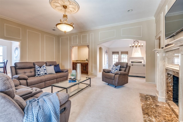 2701 Shadow Dr W, Arlington, TX 76006 - living room featuring light colored carpet, arched walkways, an inviting chandelier, ornamental molding, and a premium fireplace