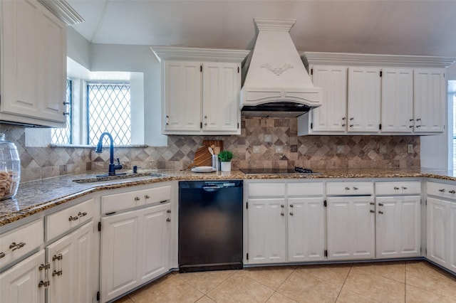 kitchen with light tile patterned floors, custom range hood, black appliances, white cabinetry, and a sink