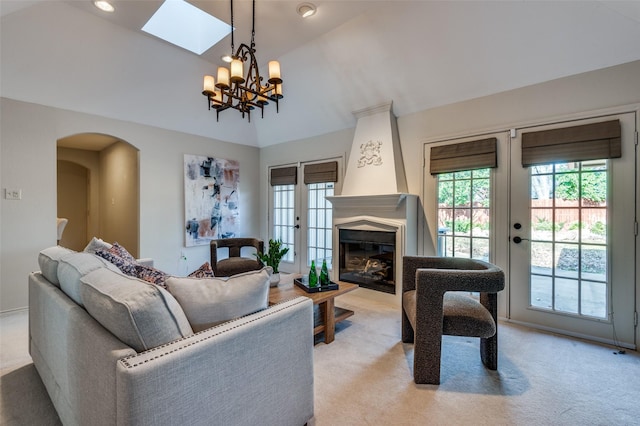 2701 Shadow Dr W, Arlington, TX 76006 - living room featuring light colored carpet, a chandelier, and vaulted ceiling with skylight
