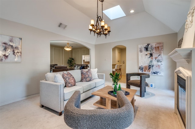 living room with light colored carpet, visible vents, vaulted ceiling, and arched walkways