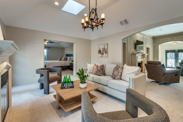 living room with arched walkways, a fireplace, lofted ceiling, light colored carpet, and visible vents