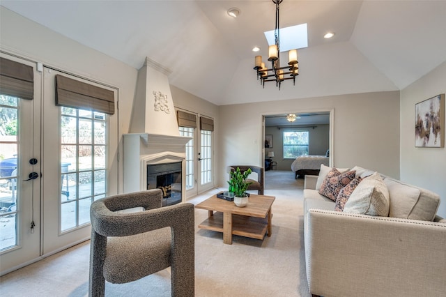 living area featuring light carpet, french doors, vaulted ceiling, and plenty of natural light