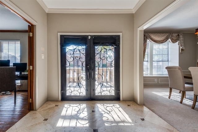 tiled entryway featuring french doors, crown molding, and baseboards